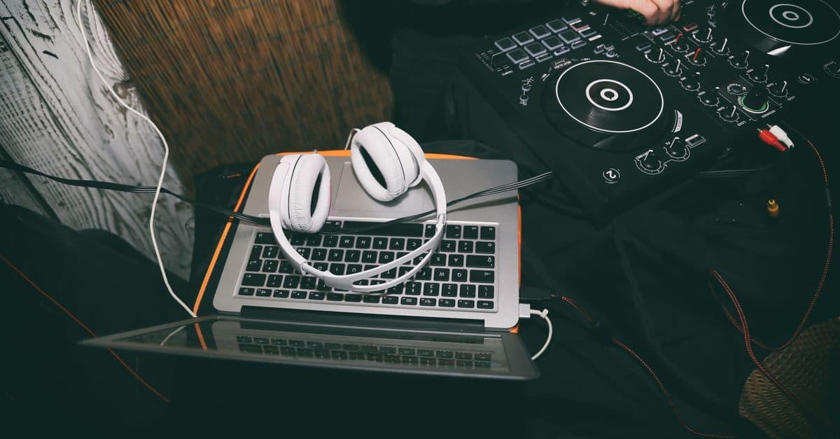 Laptop with headphones and DJ controller