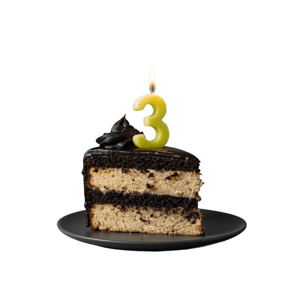 Slice of birthday cake with a 3 candle