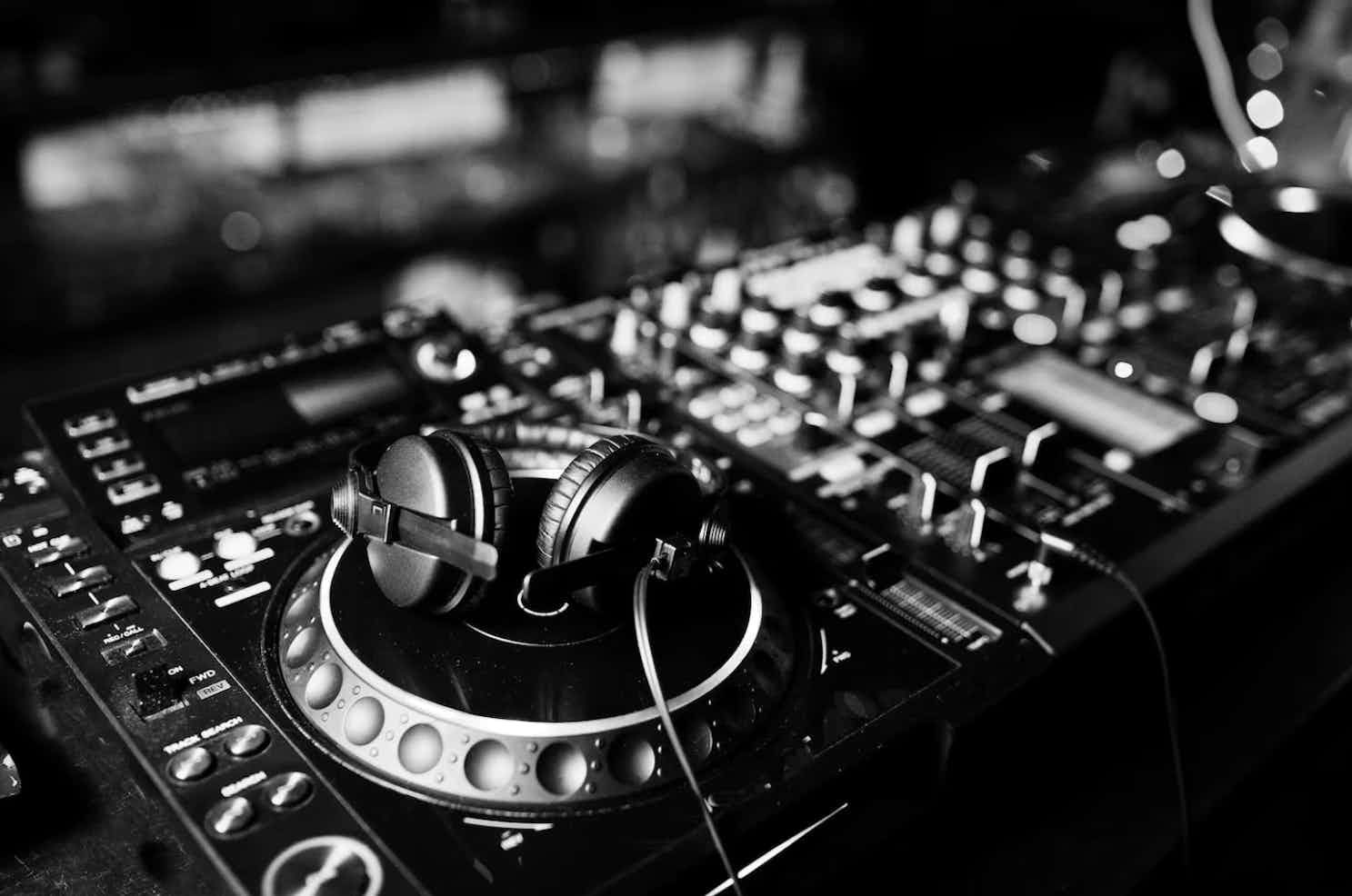 An image of a pair of headphones laying on top of some CDJ's.